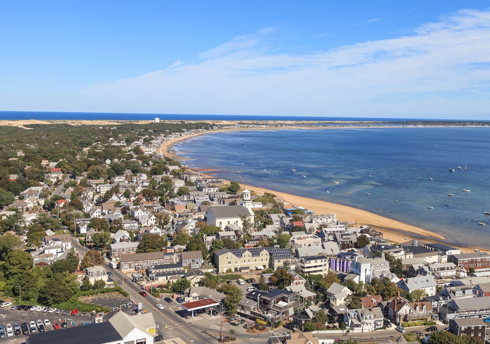 Aerial view of Provincetown's houses along the curving beach of Cape Cod Bay